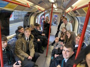 Students on the tube on their way to the theatre