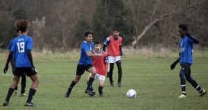 Young football players playing a football match. 