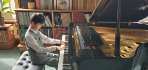 Picture of Chapman playing piano.