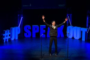 A young boy in school uniform on stage at the Jack Petchey’s Speak Out Challenge 2025