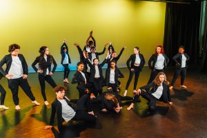 Group of young people on stage dancing