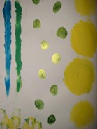 An abstract painting on white paper featuring various colorful shapes and strokes. On the left side, there are two vertical brushstrokes in blue and green. To the right, there are multiple green circular spots arranged in a loose vertical pattern. Further right, there are several large yellow circles, also aligned vertically. At the bottom left, there are small yellow and green blotches clustered together. The overall composition appears playful and experimental, using bright colors and simple shapes.