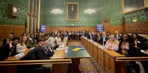 Young people and adults sat in a court-style room.